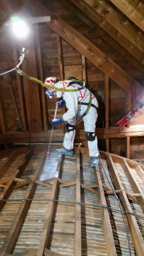 HPCS USA technician spray applies consolidant to back of plaster ceiling.